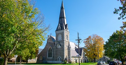 Gothic style church with stained glass windows and a tower